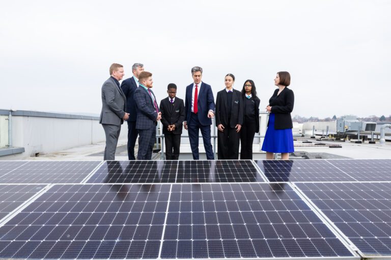 Ed Milliband in front of a solar panel as part of GB energy push
