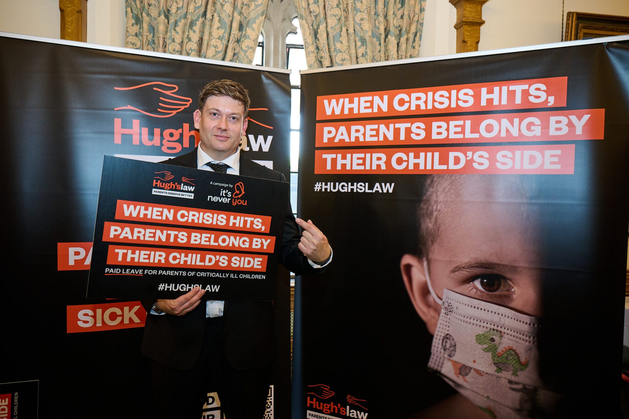 Hugh's Law advocate holds up sign