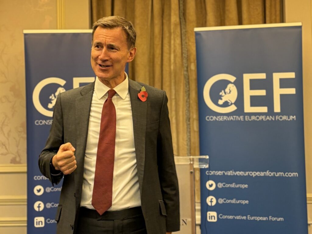 Jeremy Hunt speaking on Britain's Role in the World at a CEF Reception, in front of banners.