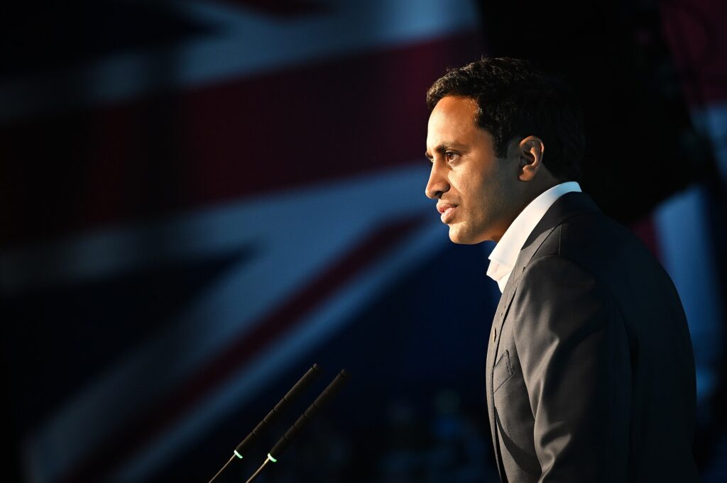 Reform UK member Zia Yusuf addressing a crowd of people.
