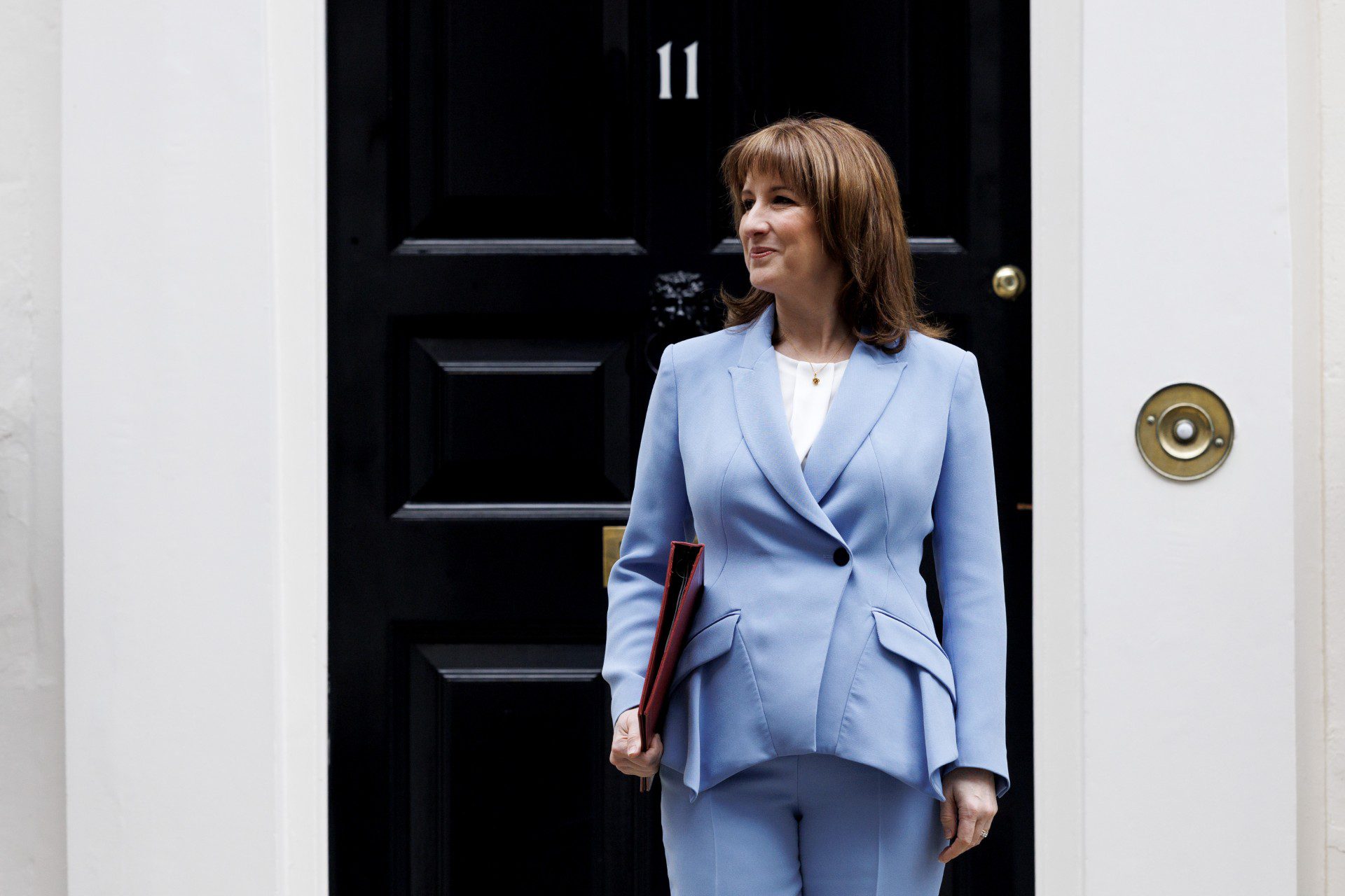 Chancellor Rachel Reeves in light blue suit outside 11 Downing Street before the Spring Statement