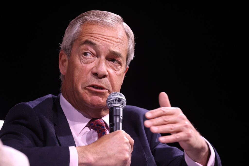Leader of Reform UK Nigel Farage, holding a microphone